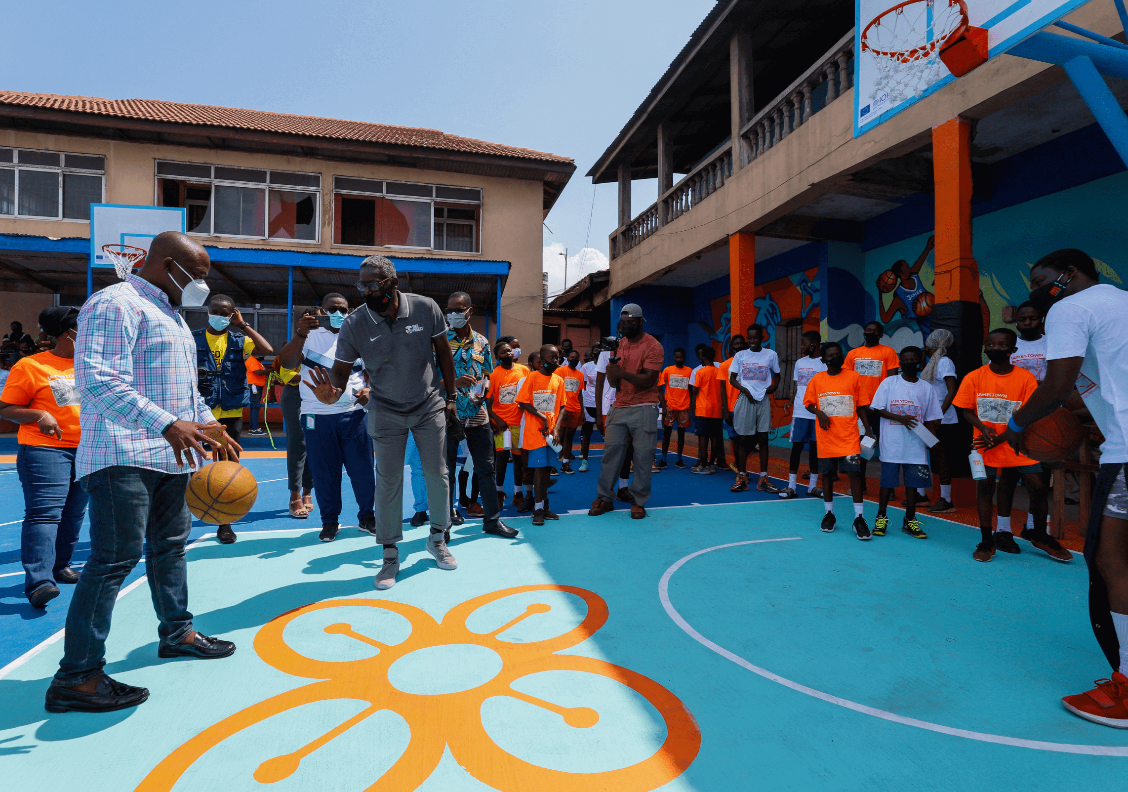 Kids playing basketball on an outdoor court